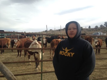  Walee Crittendon stands with her family's livestock after the initial theft by armed rangers. (Photo Credit: Censored News)